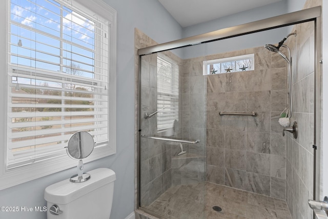 bathroom featuring toilet and walk in shower