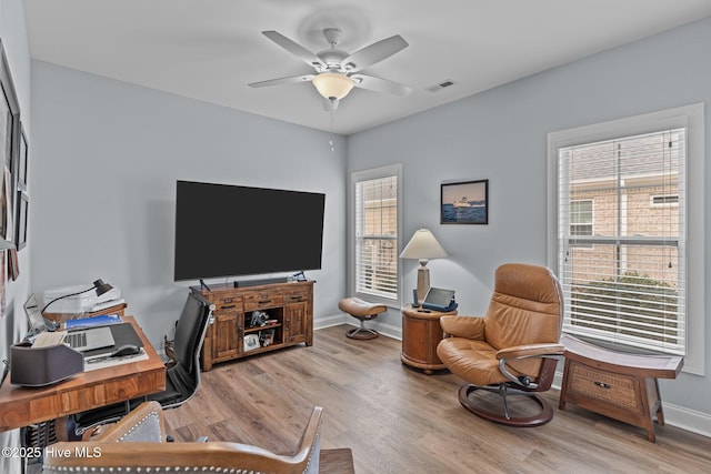 office with ceiling fan and light hardwood / wood-style flooring