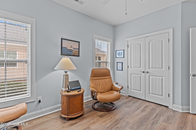 sitting room featuring ceiling fan and light hardwood / wood-style floors