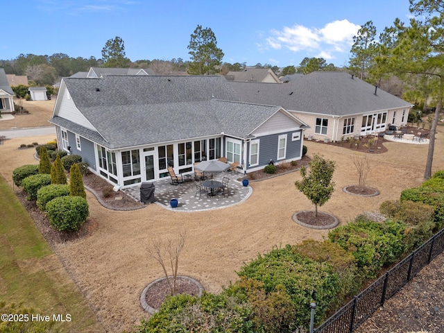 back of property featuring a sunroom and a patio