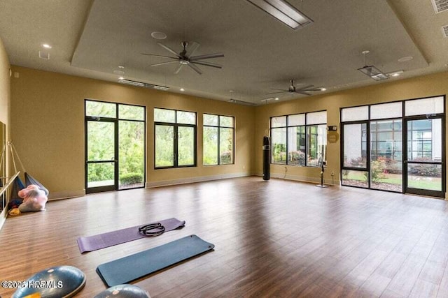 workout area featuring ceiling fan and light wood-type flooring