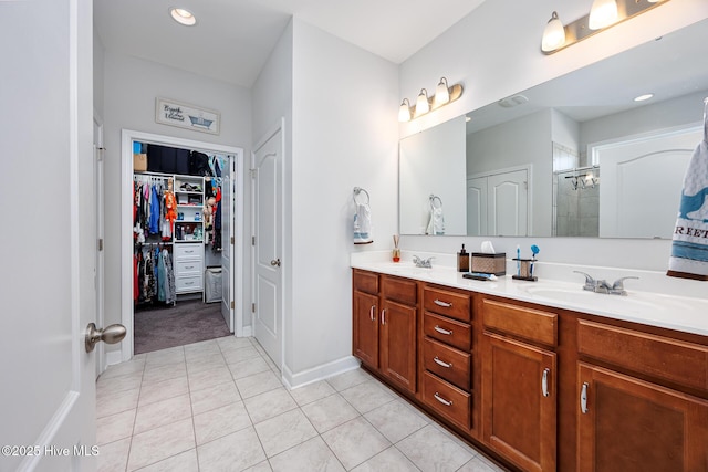 bathroom featuring tile patterned floors, vanity, and a shower with shower door