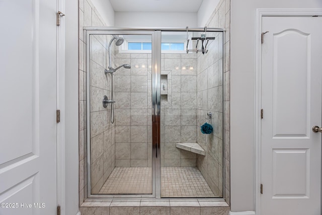 bathroom featuring a shower with door