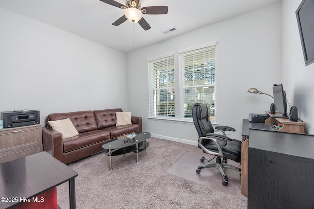 carpeted home office featuring ceiling fan