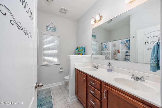 bathroom featuring tile patterned flooring, vanity, and toilet