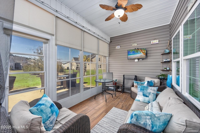 sunroom / solarium featuring ceiling fan