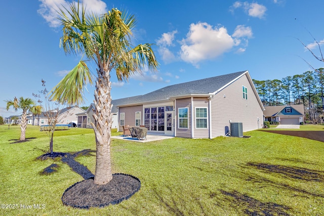 rear view of house featuring cooling unit, a yard, and a patio