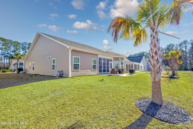 rear view of house featuring a yard and a patio area