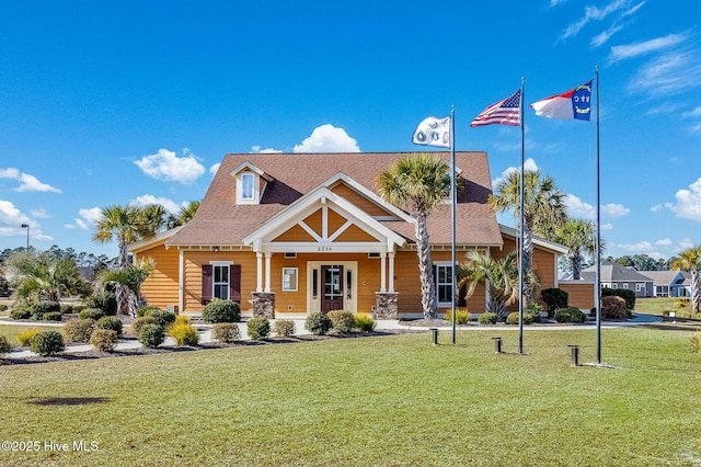 view of front of house featuring covered porch and a front lawn