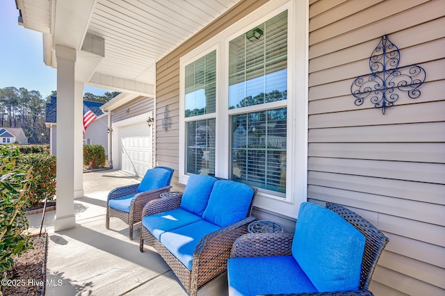 view of patio with a garage and covered porch