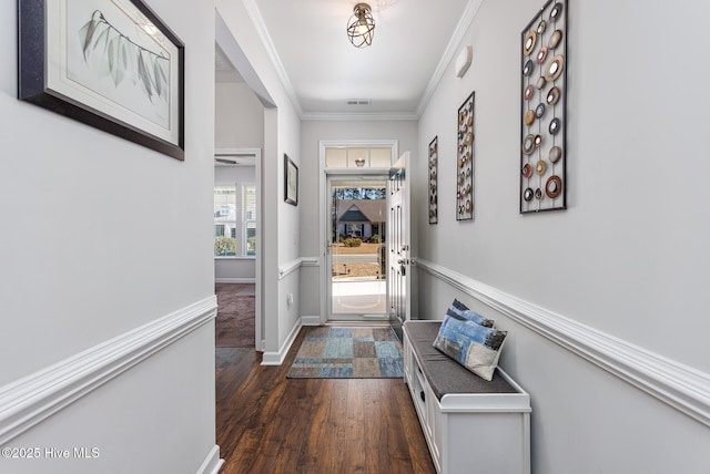 doorway to outside with ornamental molding and dark hardwood / wood-style flooring