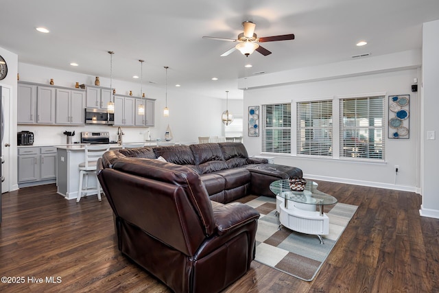 living room with dark hardwood / wood-style floors and ceiling fan