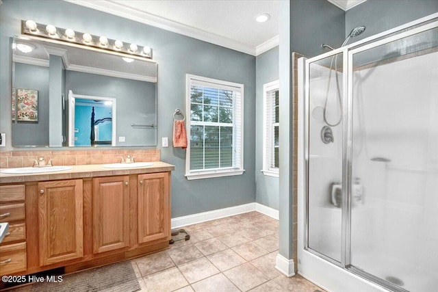 full bath with a stall shower, crown molding, and a sink