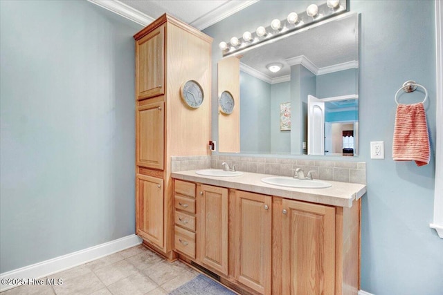 bathroom featuring ornamental molding, a sink, baseboards, and double vanity