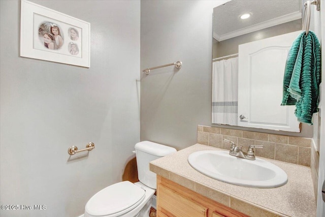 full bathroom featuring toilet, crown molding, backsplash, and vanity