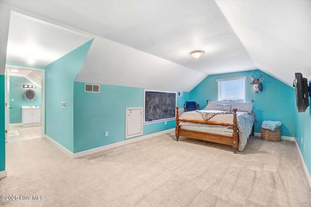 carpeted bedroom with vaulted ceiling, visible vents, and baseboards