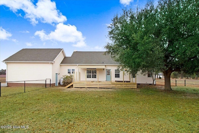 back of property with a deck, a yard, crawl space, and fence