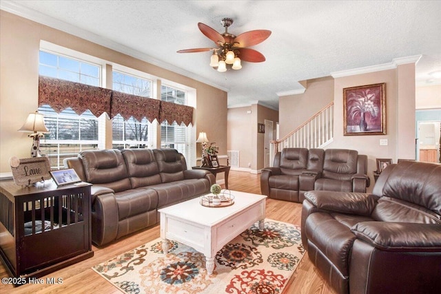 living room with light wood finished floors, a textured ceiling, and a wealth of natural light