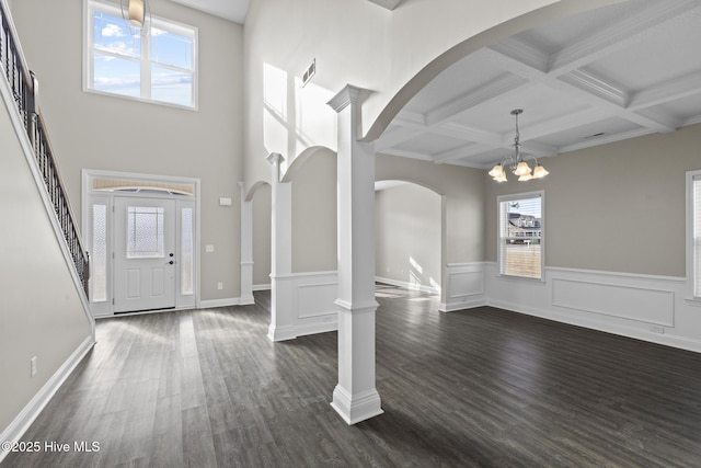 entrance foyer with coffered ceiling, dark hardwood / wood-style flooring, decorative columns, and beam ceiling