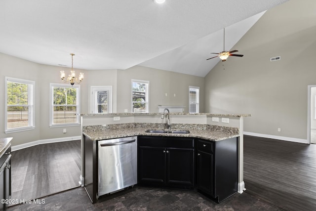 kitchen with lofted ceiling, sink, a center island with sink, stainless steel dishwasher, and pendant lighting