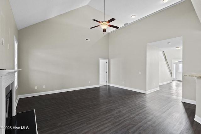 unfurnished living room featuring ceiling fan, high vaulted ceiling, and dark hardwood / wood-style flooring