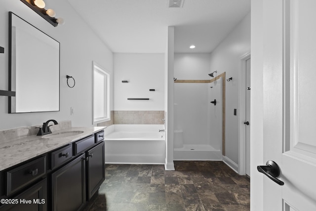 bathroom with vanity and independent shower and bath