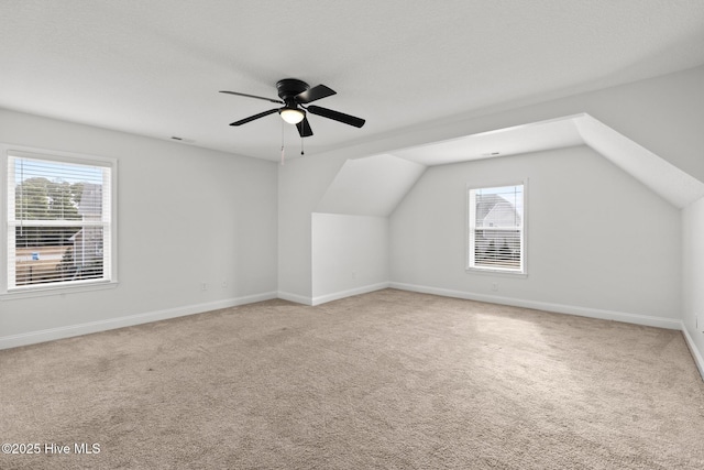 bonus room featuring ceiling fan, light colored carpet, and vaulted ceiling