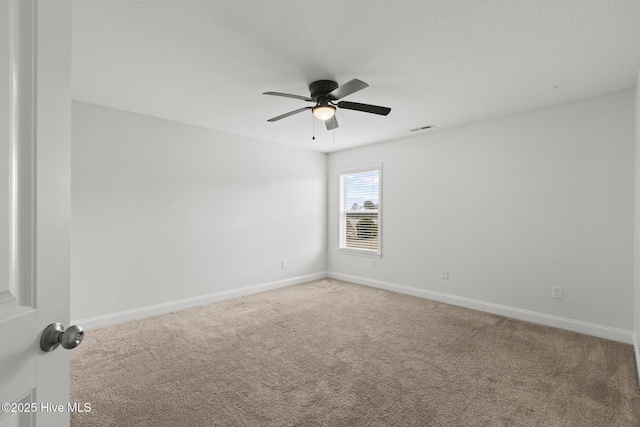 empty room with carpet floors, a textured ceiling, and ceiling fan