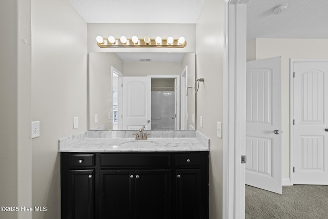 bathroom with vanity and a textured ceiling