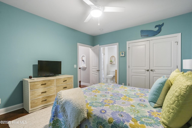 bedroom featuring ceiling fan, ensuite bath, dark hardwood / wood-style floors, and a closet