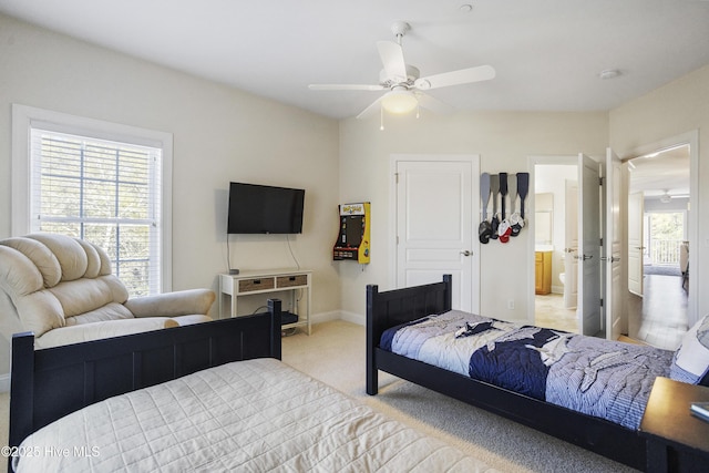 carpeted bedroom with ceiling fan and ensuite bathroom