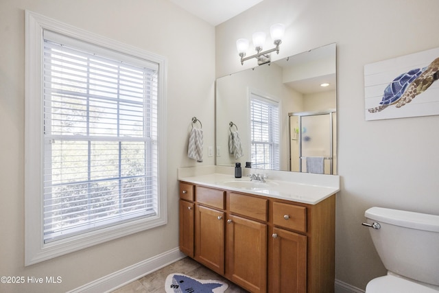 bathroom with vanity, toilet, and a shower with shower door