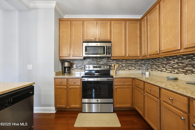 kitchen with dark wood-type flooring, stainless steel appliances, light stone countertops, and backsplash