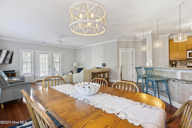 dining area with ornamental molding, dark hardwood / wood-style floors, and ceiling fan