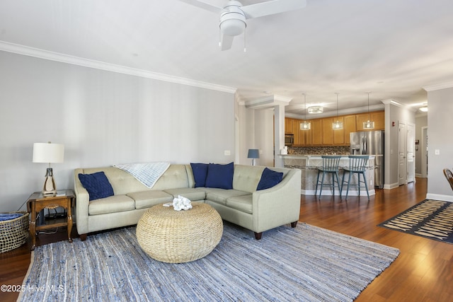 living room featuring crown molding, ceiling fan, and dark hardwood / wood-style flooring