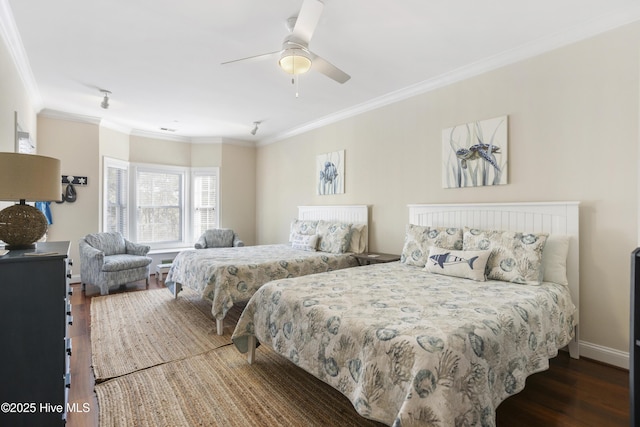 bedroom featuring ornamental molding, dark wood-type flooring, and ceiling fan