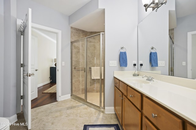 bathroom featuring vanity and a shower with door