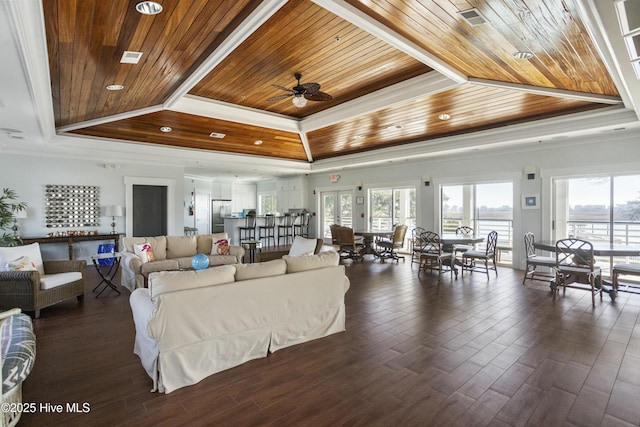 living room featuring dark wood-type flooring, ceiling fan, ornamental molding, wooden ceiling, and a raised ceiling