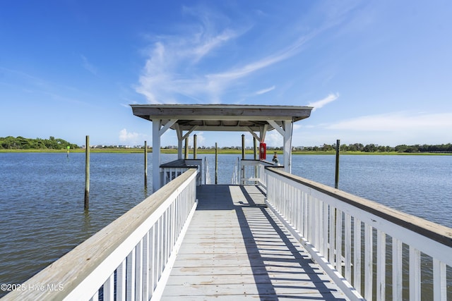 view of dock with a gazebo and a water view