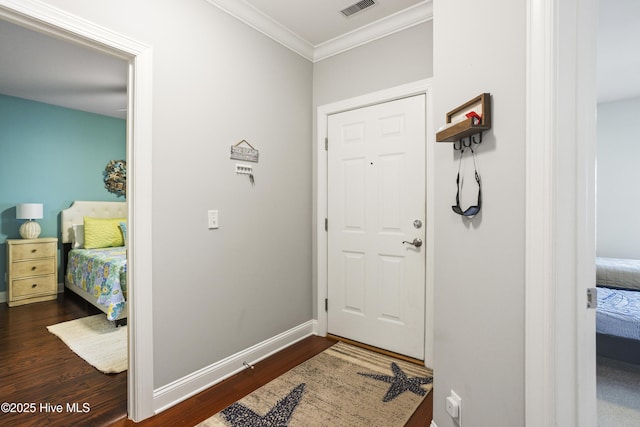 entrance foyer with crown molding and dark hardwood / wood-style floors