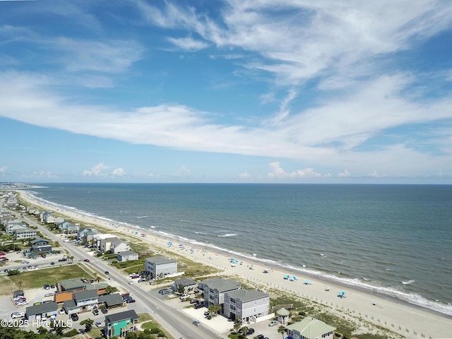 drone / aerial view with a water view and a beach view