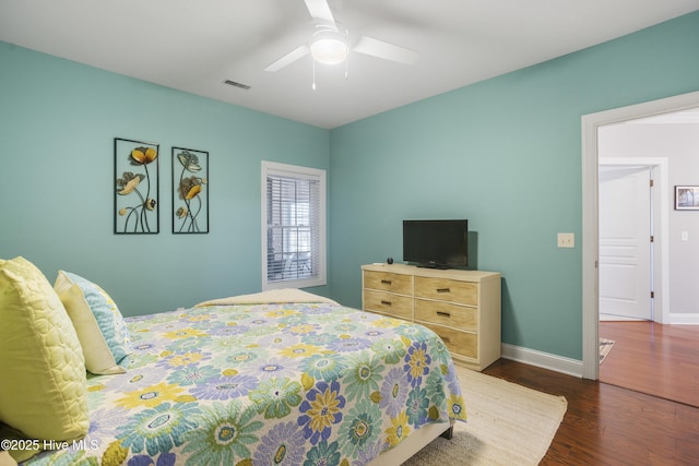 bedroom with ceiling fan and dark hardwood / wood-style floors