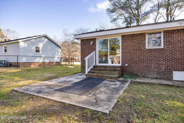 back of house with cooling unit, a yard, and a patio area