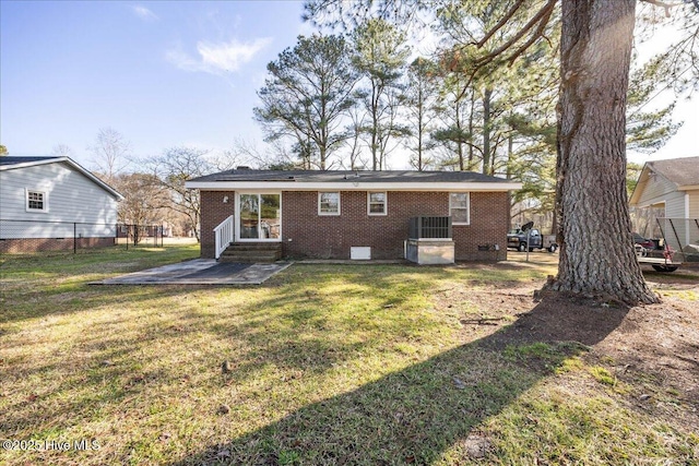 rear view of house featuring a yard and a patio area