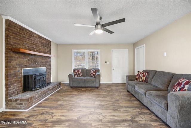 living room with dark hardwood / wood-style flooring, ceiling fan, and a textured ceiling