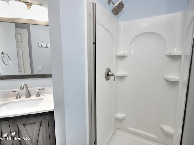 bathroom with a shower and vanity