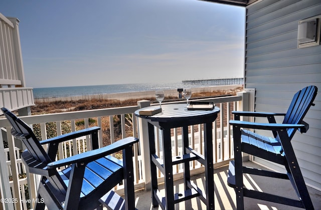 balcony with a beach view and a water view