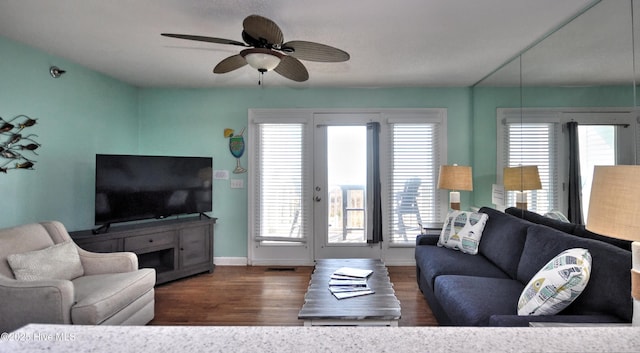 living room featuring dark hardwood / wood-style flooring and ceiling fan