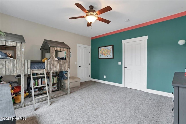 carpeted bedroom featuring ceiling fan and baseboards