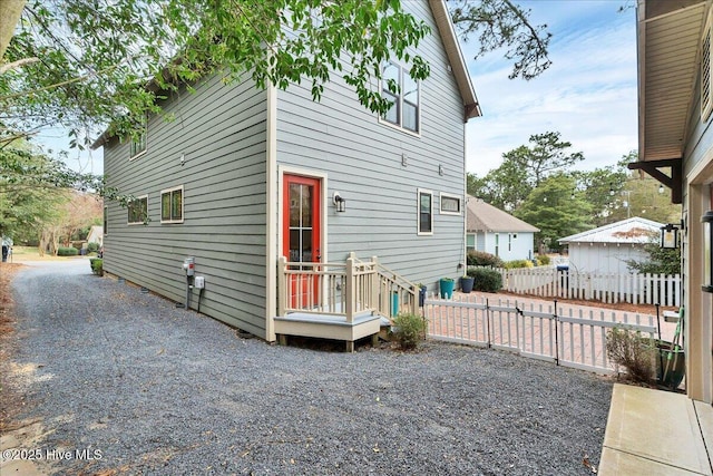 rear view of property featuring fence